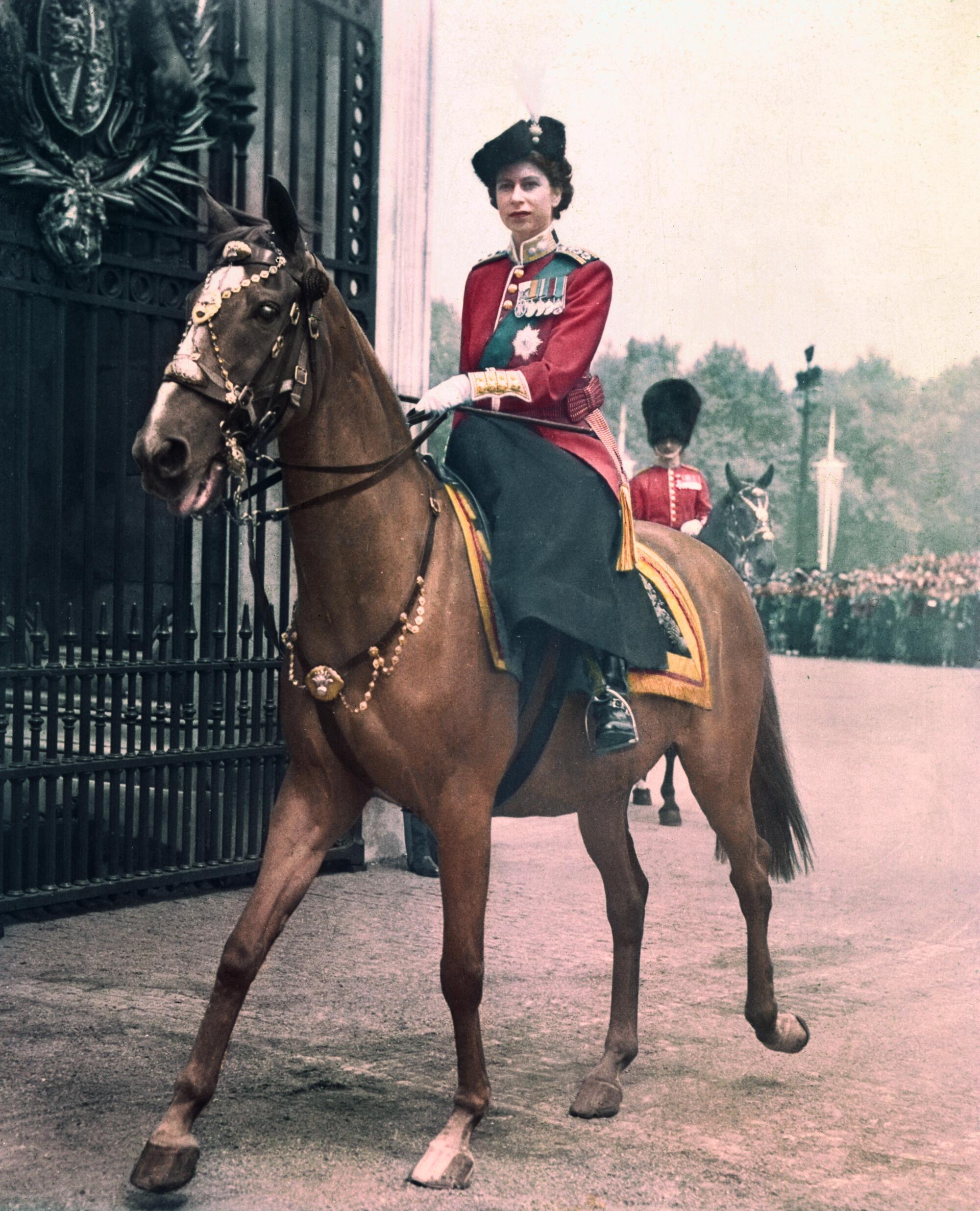 Princess Elizabeth of England represents the King at colorful trooping ceremony.