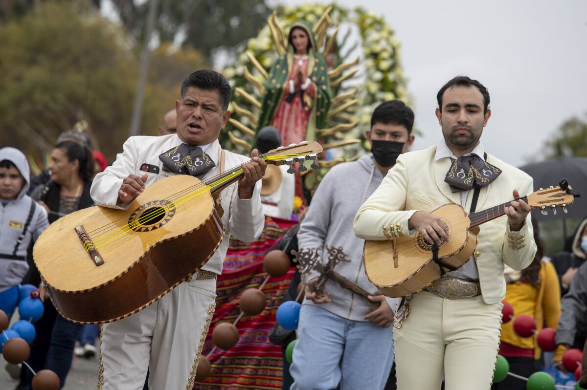 Mariachis play during the 91st annual Virgen de Guadalupe procession on Sunday in East Los Angeles.