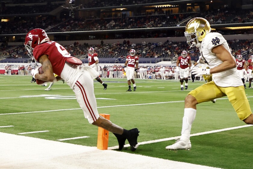 Alabama wide receiver DeVonta Smith (6) catches a pass in the end zone for a touchdown as Notre Dame cornerback Nick McCloud, right, defends in the second half of the Rose Bowl NCAA college football game in Arlington, Texas, Friday, Jan. 1, 2021. (AP Photo/Michael Ainsworth)