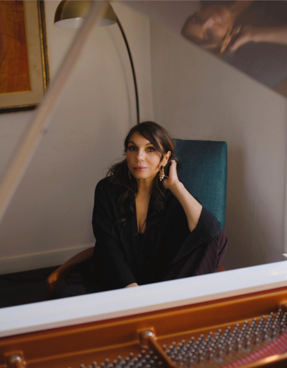 A woman sits at a piano. 