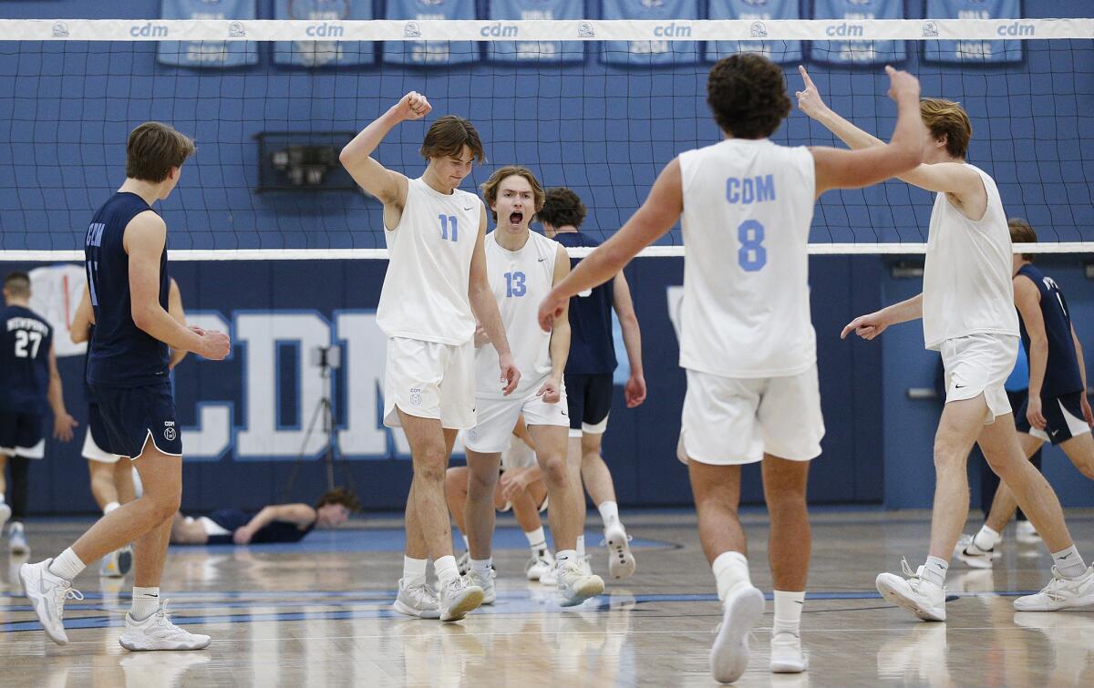 Corona del Mar players celebrate a point against Newport Harbor on April 4.