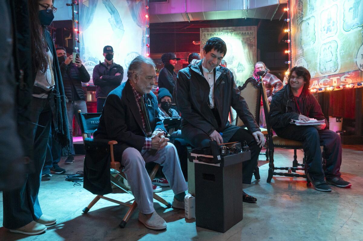 Francis Ford Coppola and actor Adam Driver converse in adjacent chairs on the set of "Megalopolis" 