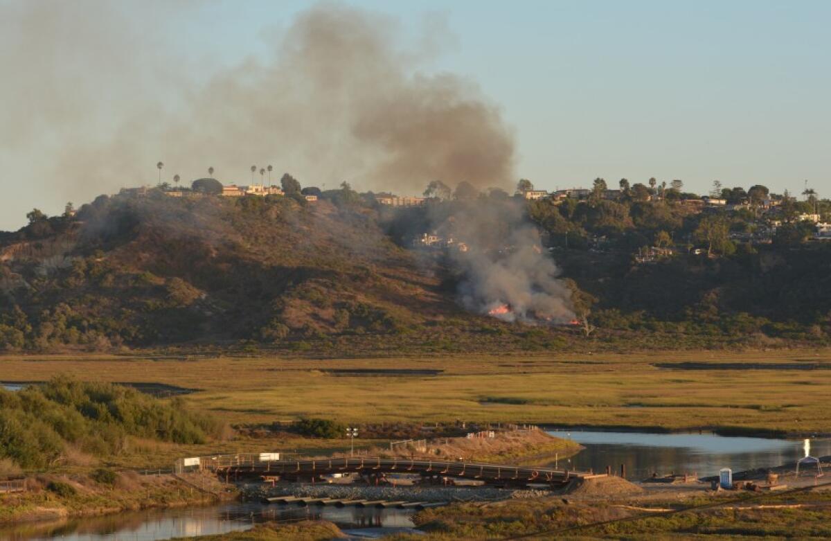 A small brush fire burned near the San Elijo Lagoon in Solana Beach Thursday, Oct. 3, 2019.