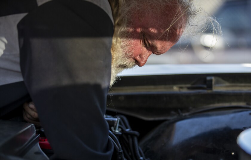 Joe Miracle, 70, works on a 1970 Chevy Impala at his shop, Bay Auto Service in Costa Mesa on Thursday.