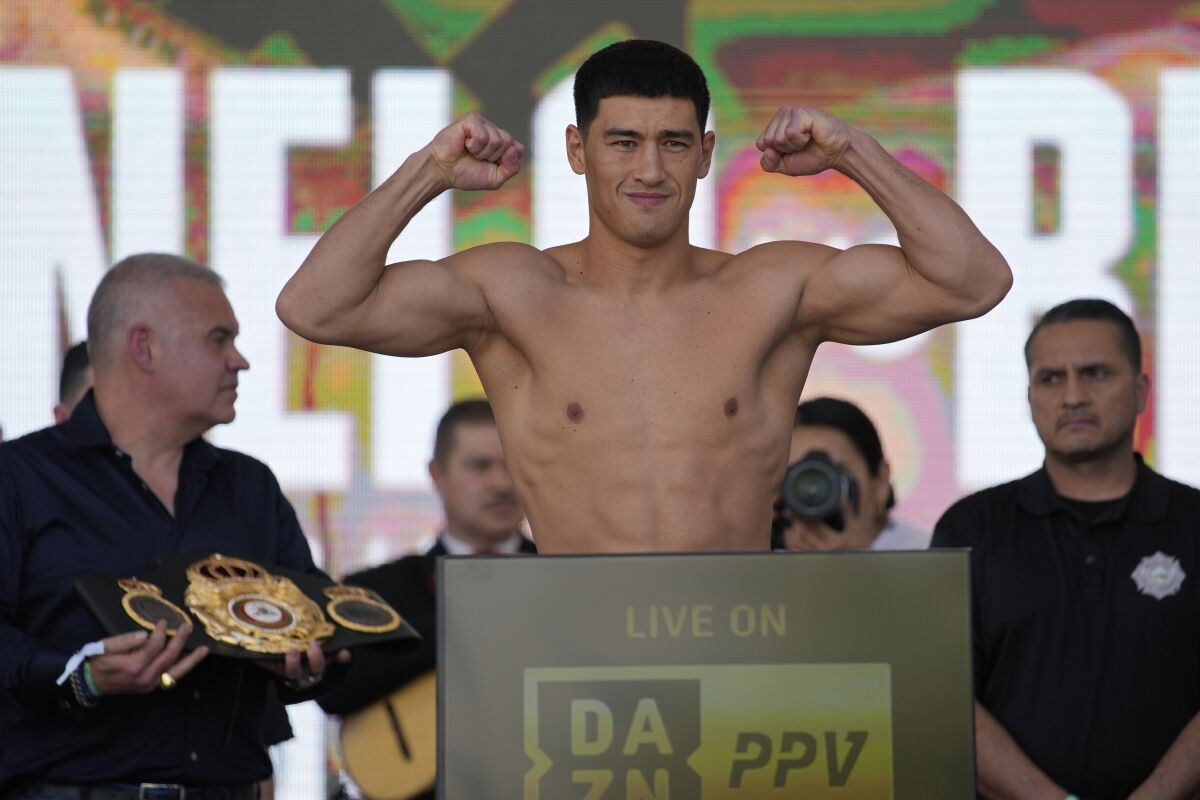 Dmitry Bivol poses during a ceremonial boxing weigh-in Friday in Las Vegas.