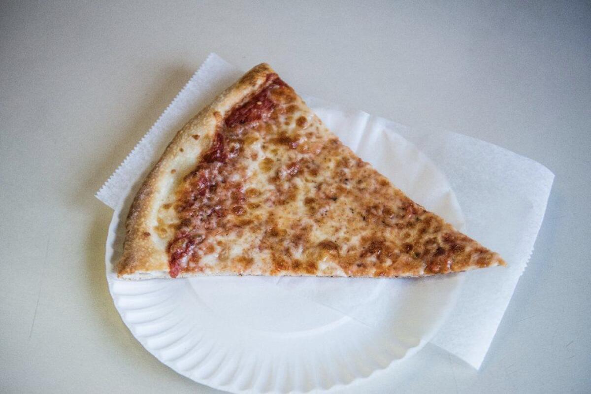 A slice of "pizza," a fascinating food popular in New York.