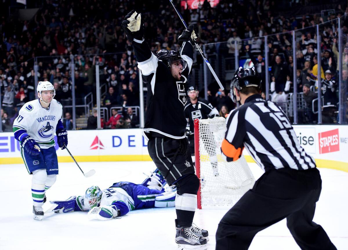 Kings forward Anze Kopitar celebrates his overtime goal in front of the Canucks' Radim Vrbata (17) and goalie Jacob Markstrom (25) to give the Kings a 2-1 victory.