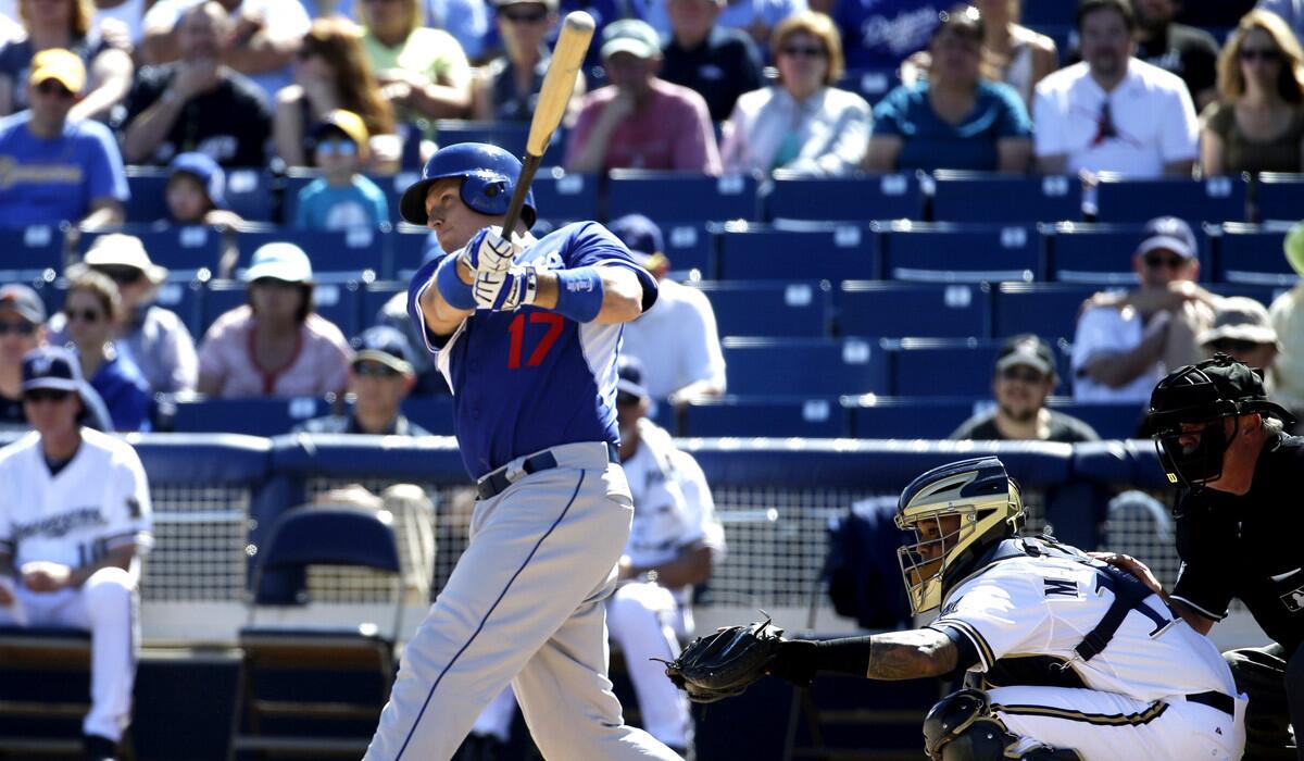 Dodgers catcher A.J. Ellis hits a three-run home run during a spring training game against the Milwaukee Brewers on Friday.