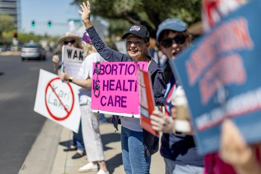PHOENIX, AZ - APRIL 16, 2024: Arizona residents rally for abortion rights on a street corner Tuesday on the heels of the Arizona's Supreme Court decision enacting an 1864 law banning abortion on April 16, 2024 in Phoenix, Arizona.(Gina Ferazzi / Los Angeles Times)