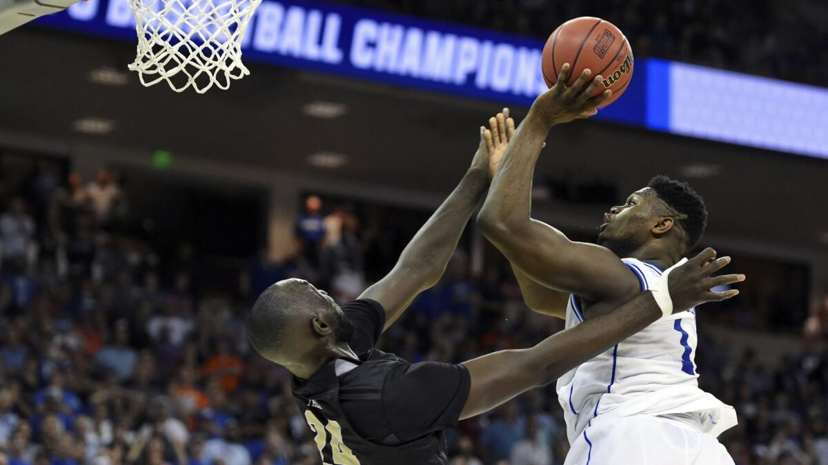 Duke's Zion Williamson, right, shoots over Central Florida's Tacko Fall during the second half.