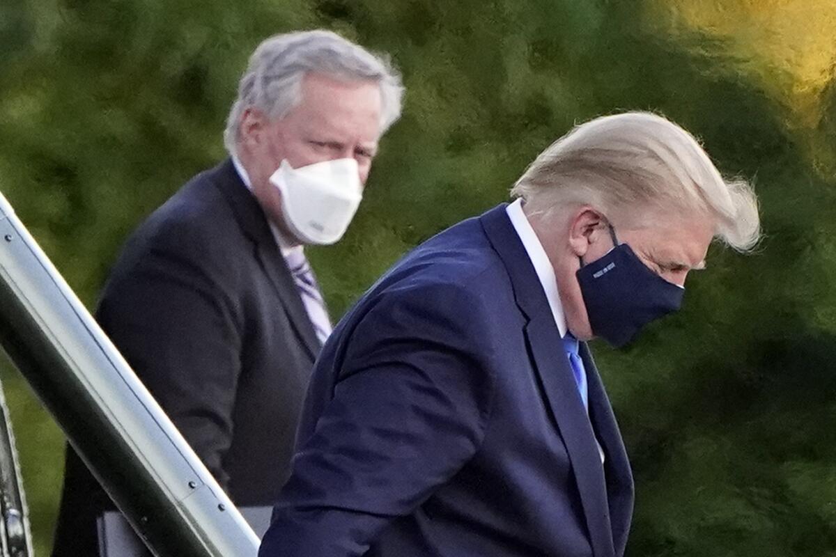 President Trump wears a mask as he arrives at Walter Reed National Military Medical Center in Bethesda, Md.