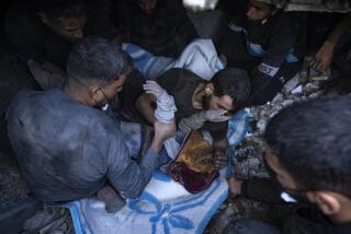 Palestinians pull a body out of the rubble of a residential building destroyed in an Israeli airstrike, in Rafah, southern Gaza Strip, Friday, Dec. 15, 2023. (AP Photo/Fatima Shbair)