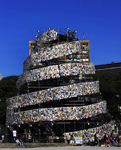 The installation was constructed with books donated by more than 50 countries. In biblical literature, the Babylonians were constructing a grand city to raise their profile, and it included a tower that would reach the heavens, the Tower of Babel. Seeing this, God dispersed them and gave them different languages so they couldn't communicate with one another. The city and tower were never finished.