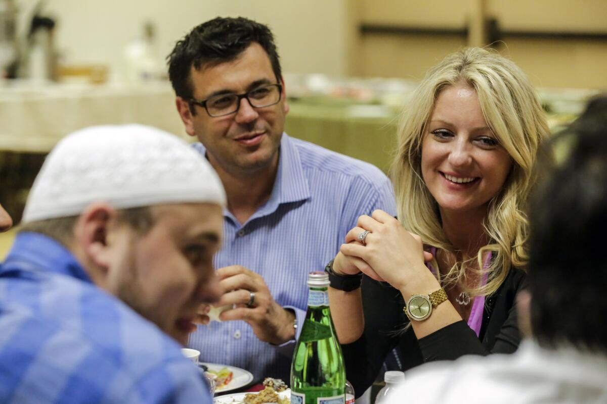 Bosniaks Cultural Community of Southern California's President Halil Hasic, center, with his wife, Selma, at an iftar party held at the Heritage Park Community Center.