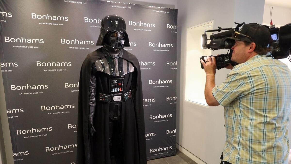 A Darth Vader costume from "Star Wars: Episode V — The Empire Strikes Back" is shown on display at Bonhams auctioneers in Los Angeles. The item was withdrawn from the auction, according to Bonhams' website.