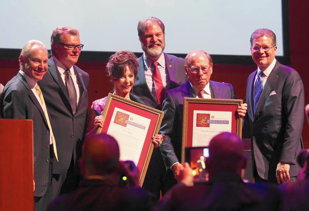 Julia and George Argyros receive the Lifetime Achievement Award during Costa Mesa's fourth annual Mayor's Celebration: The Art of Leadership dinner on Thursday at the Samueli Theater at the Segerstrom Center for the Arts. Also pictured, from left, are journalist Rick Reiff, Mayor Steve Mensinger, state Sen. John Moorlach and Arnel and Affiliates Chief Executive Kevin Hauber.