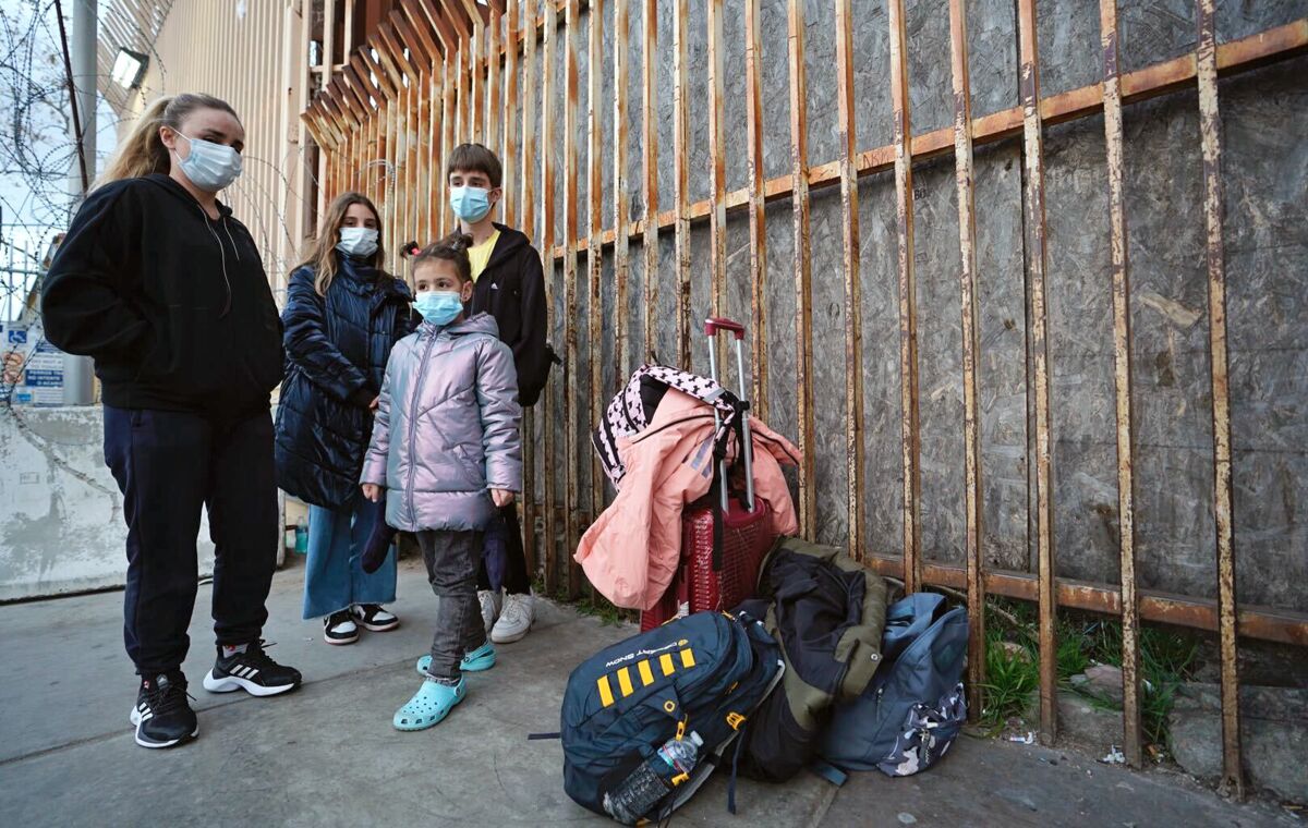 A Ukrainian family stands by the pedestrian entrance at the San Ysidro Port of Entry