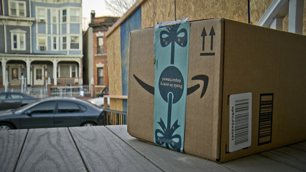 An Amazon delivery box on a porch.
