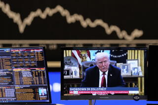President Trump appears on a TV screen at the stock market in Frankfurt on April 2.