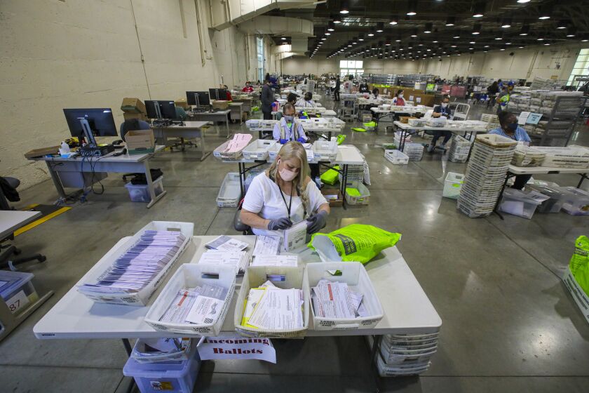 POMONA, CA - NOVEMBER 04: Patricia Fitzgerald sorts incoming mail-ballots at Los Angeles County Registrar facility at Fairplex on Wednesday, Nov. 4, 2020 in Pomona, CA. (Irfan Khan / Los Angeles Times)