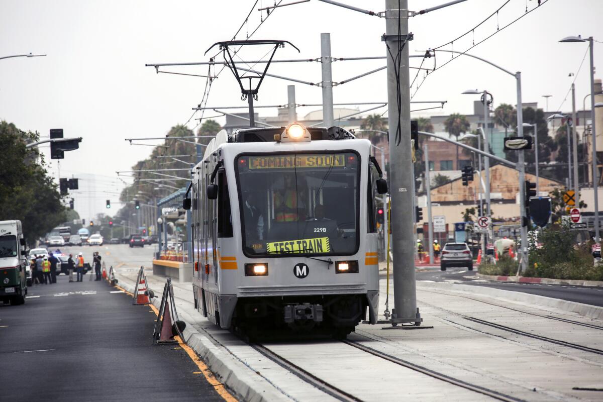 An Expo Line test train moves into Santa Monica during a July test run. A light-rail train derailed after striking a truck that crossed the tracks.