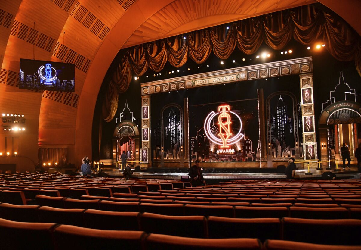 An elaborate stage and theater with velvet and gold accents.