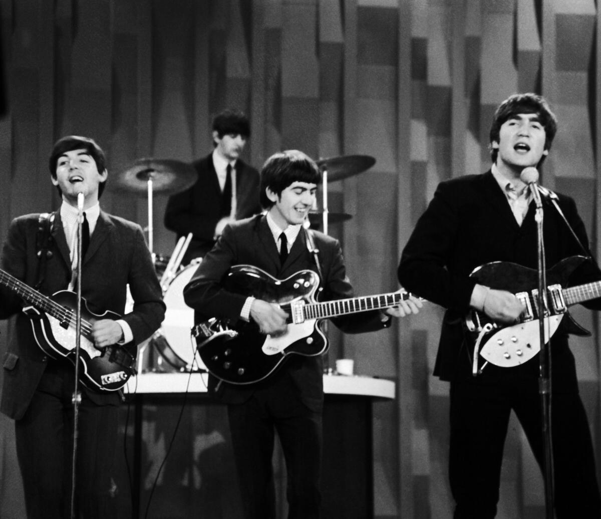 The Beatles, from left, Paul McCartney, Ringo Starr on drums, George Harrison and John Lennon, perform for CBS' "The Ed Sullivan Show" in New York on Feb. 9, 1964.