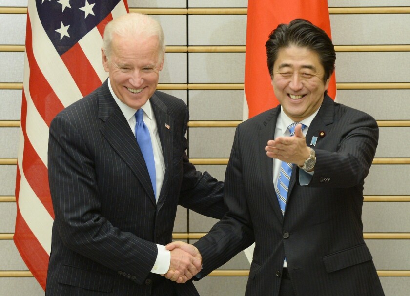 Vice President Joe Biden, left, is welcomed by Japanese Prime Minister Shinzo Abe prior to talks at Abe's official residence in Tokyo.