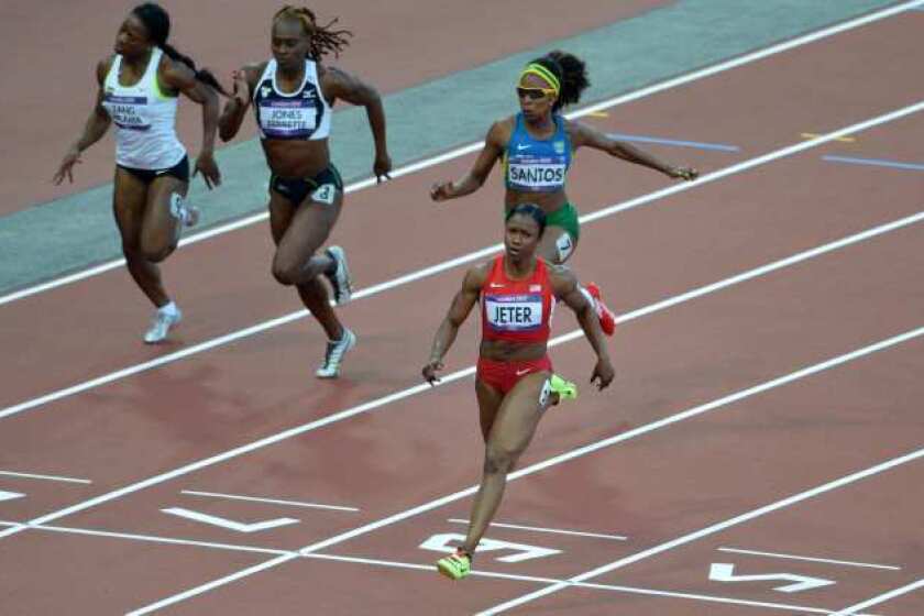 Carmelita Jeter crosses the finish line first in her 100-meter semifinal race.