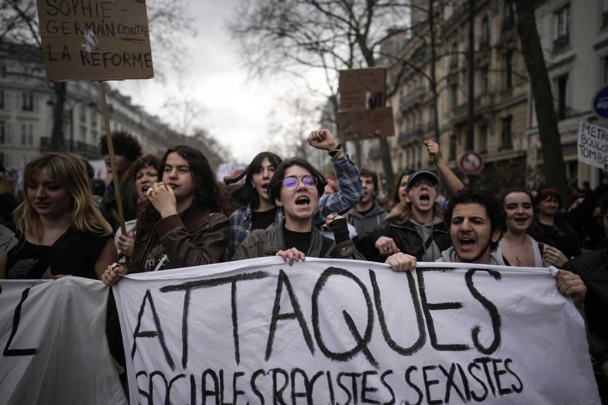 FILE - Protesters march during a rally in Paris, on March 23, 2023. French President Emmanuel Macron has ignited a firestorm of anger with unpopular pension reforms that he rammed through parliament. Young people, some of them first-time demonstrators, are joining protests against him. Violence is also picking up. (AP Photo/Christophe Ena, File)