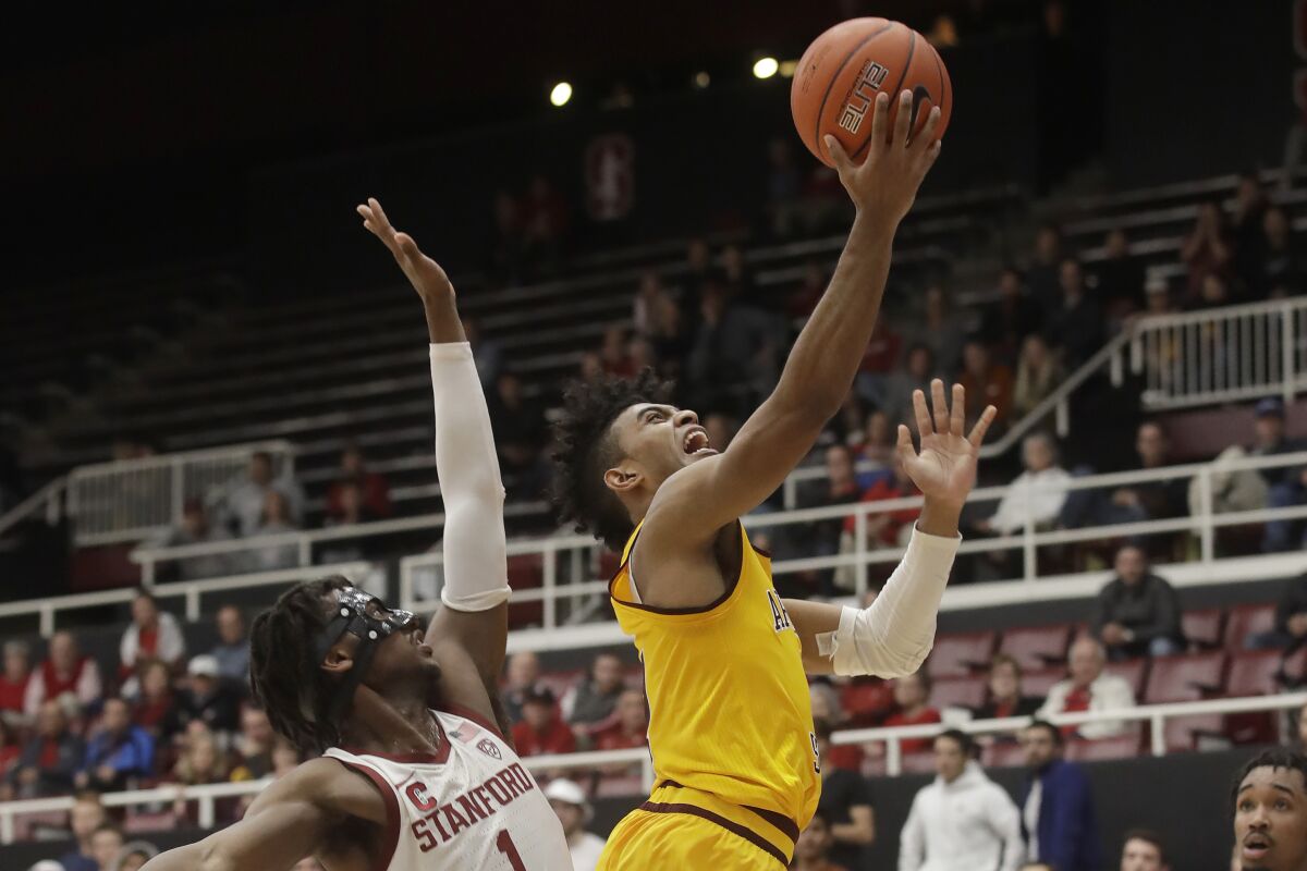 Arizona State guard Remy Martin, right, shoots next to Stanford guard Daejon Davis during the second half of an NCAA college basketball game in Stanford, Calif., Thursday, Feb. 13, 2020. (AP Photo/Jeff Chiu)