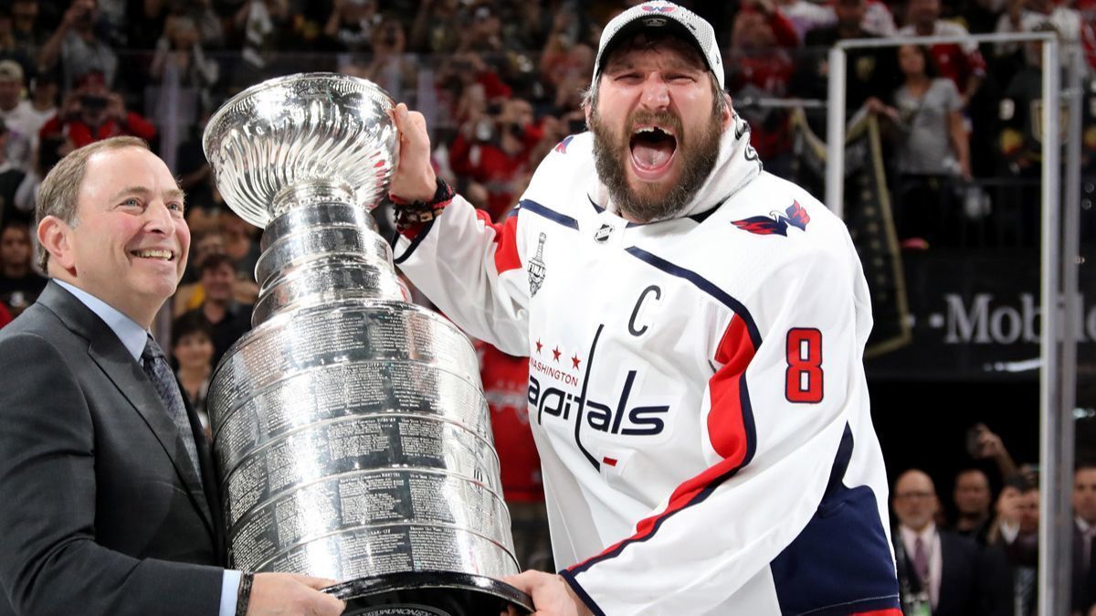 Washington Capitals' Alex Ovechkin is presented the Stanley Cup by NHL Commissioner Gary Bettman after his team defeated the Vegas Golden Knights in Game 5 of the Stanley Cup Final on Thursday.