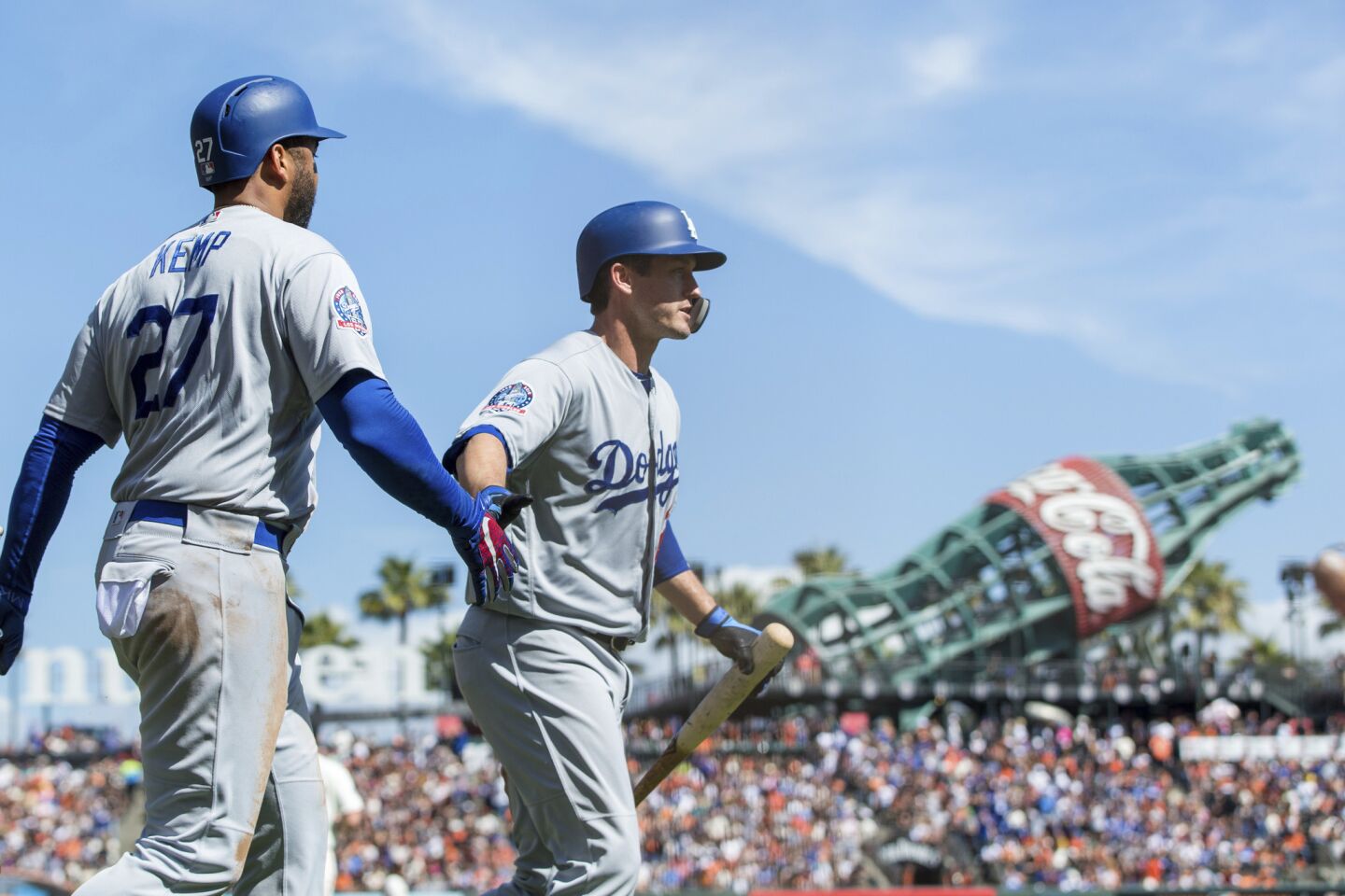 Los Angeles Dodgers Enrique Hernandez, right, celebrates with Matt Kemp after scoring a run against the San Francisco Giants in the third inning of a baseball game in San Francisco, Sunday, Sept. 30, 2018.