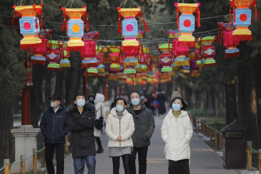 Mandatory Credit: Photo by WU HONG/EPA-EFE/REX (10537855h) People wear masks in the Jingshan Park in Beijing, China, 24 January 2020. Beijing cancelled many Spring Festival celebrations and close many scenics including the Forbidden City due to the outbreak of coronavirus. The outbreak of coronavirus has so far claimed 26 lives and infected more than 800 others, according to media reports. The virus has so far spread to the USA, Thailand, South Korea, Japan, Singapore and Taiwan. Beijing cancel the Spring Festival celebrations due to the outbreak of coronavirus, China - 24 Jan 2020 ** Usable by LA, CT and MoD ONLY **