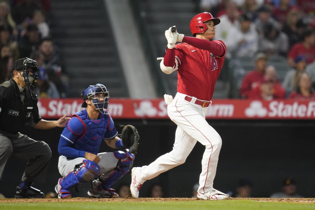 Angels star Shohei Ohtani hits a home run against the Dodgers during a spring training game.