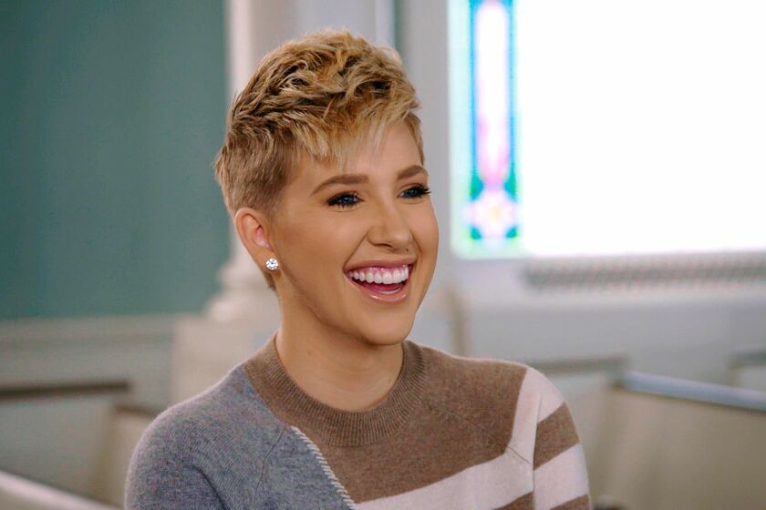 A woman with short blond hair smiles