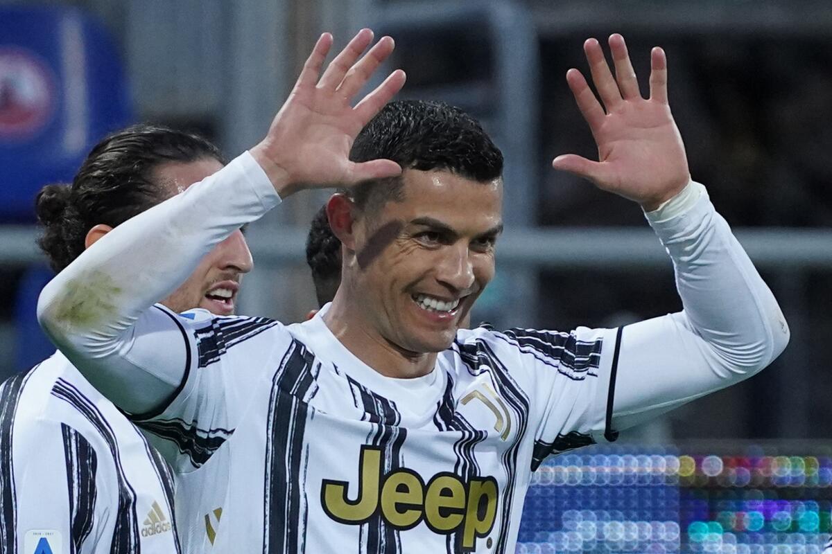 Juventus' Cristiano Ronaldo celebrates after scoring his side's third goal for his personal hat trick in thirty minutes during the Italian Serie A soccer match between Cagliari and Juventus, at the Sardegna Arena stadium in Cagliari, Italy, Sunday, March 14, 2021. (Alessandro Tocco/LaPresse via AP)