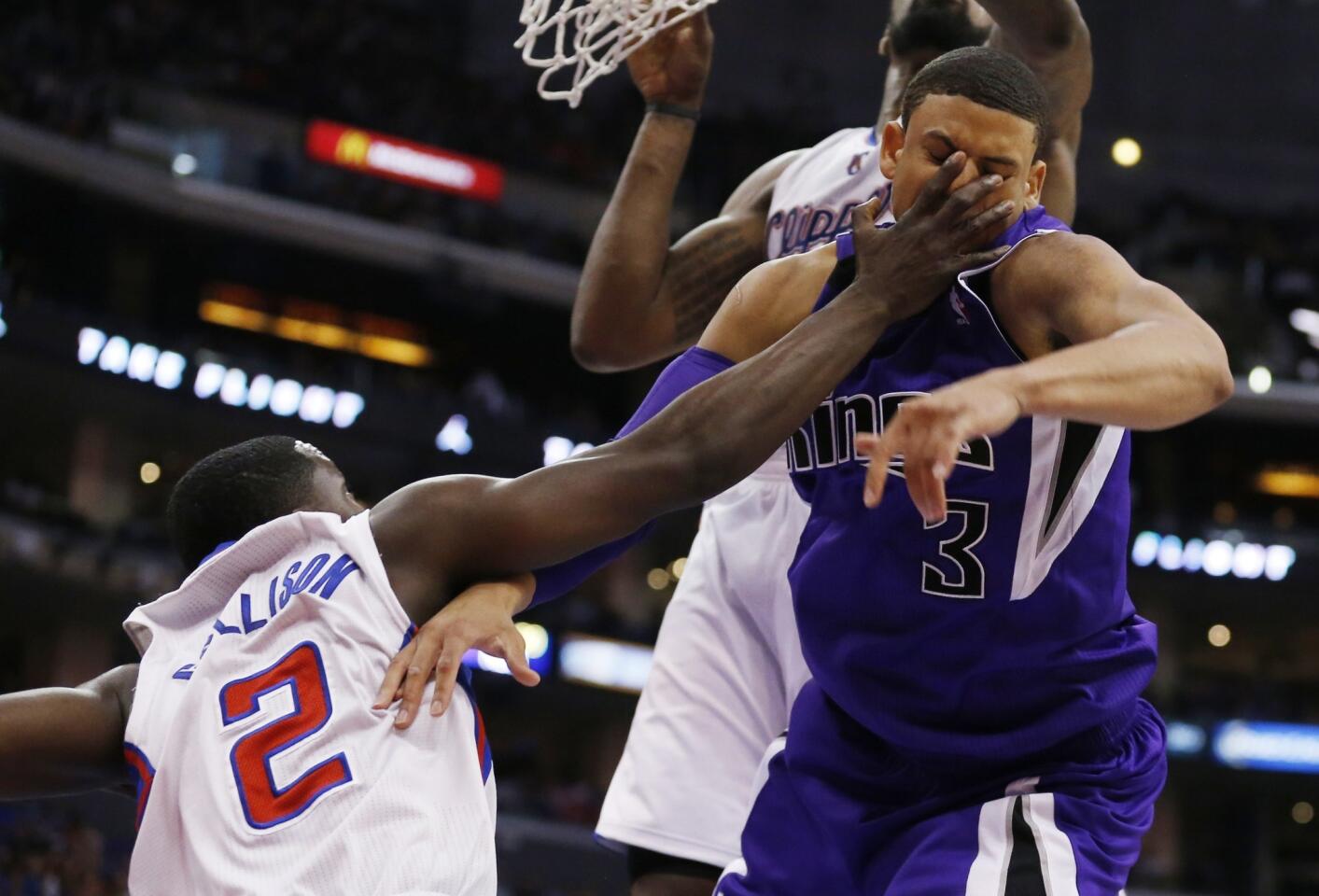Clippers guard Darren Collison hits Kings guard Ray McCallum in the face while battling for a loose ball in the second half.