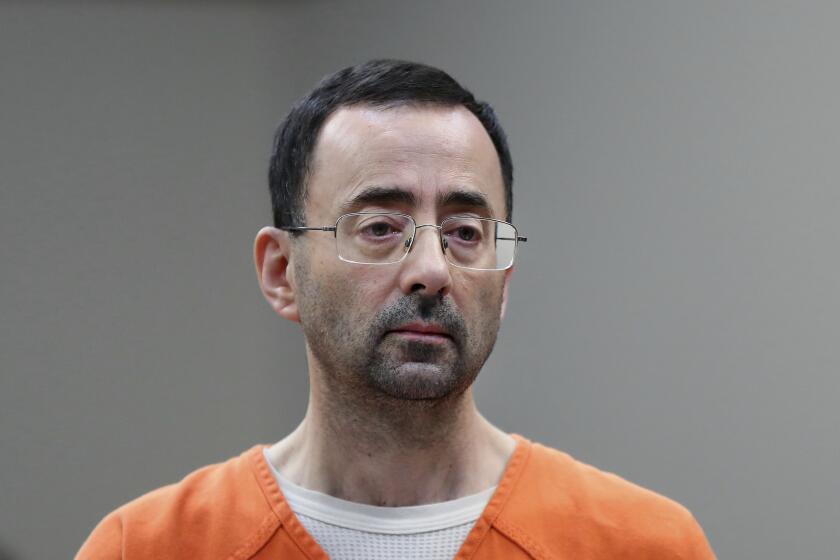 FILE - In this Nov. 22, 2017, file photo, Larry Nassar, 54, appears in court for a plea hearing in Lansing, Mich. The government's $4.5 million fine against Michigan State University in the Nassar sexual assault scandal is unprecedented. The U.S. Education Department has extraordinary leverage over schools that participate in federal student aid programs. (AP Photo/Paul Sancya, File)
