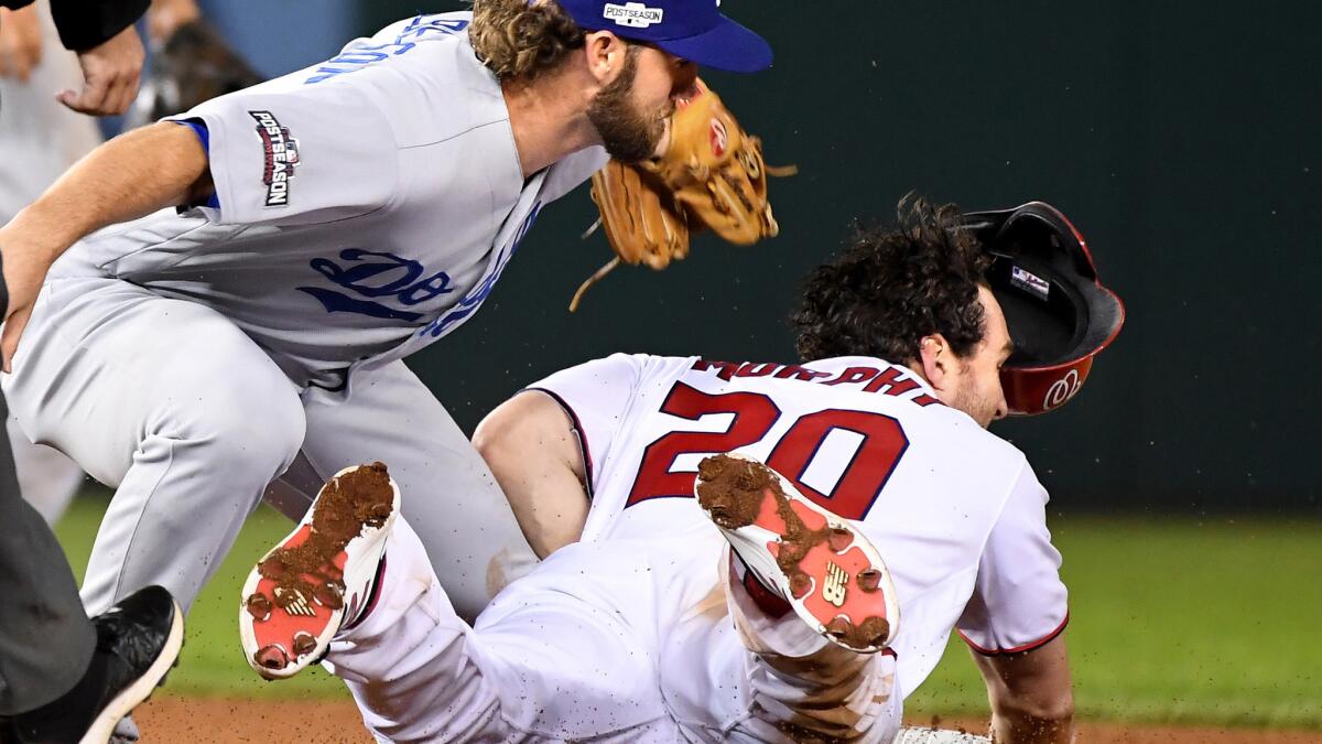 Dodgers second baseman Charlie Culberson tags out the Washington Nationals' Daniel Murphy, who tried to steal second base in the seventh inning of Game 1 on Friday.