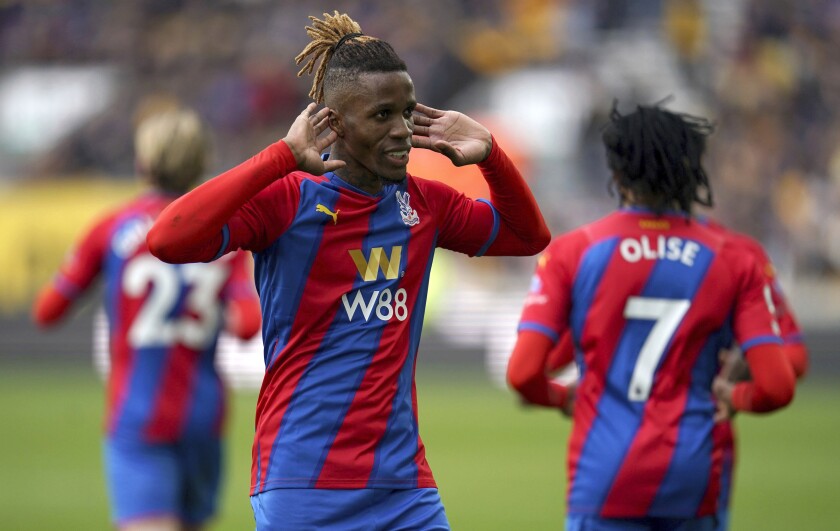 Crystal Palace's Wilfried Zaha celebrates after scoring his side's second goal during the English Premier League soccer match between Wolverhampton Wanderers and Crystal Palace, in Wolverhampton, England, Saturday March 5, 2022. (Nick Potts/PA via AP)