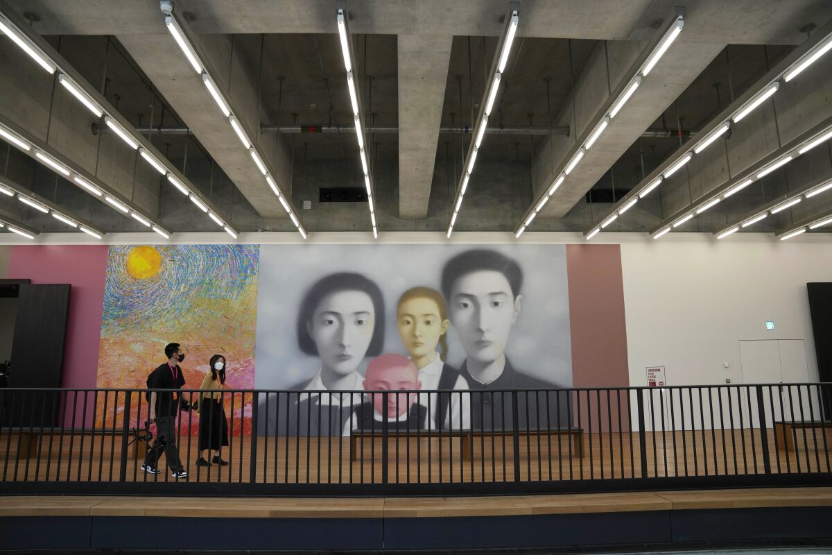 People walk inside the "M+" visual culture museum in the West Kowloon Cultural District of Hong Kong, Thursday, Nov. 11, 2021. Hong Kong's swanky new M+ museum _ Asia's largest gallery with a billion-dollar collection _ is set to open on Friday amid controversy over politics and censorship. (AP Photo/Kin Cheung)