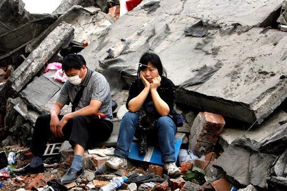 Li Wenquan, left, and wife Wang Tingting wait to learn the fate of their son, one of hundreds of students buried in rubble three days after the collapse of Dongqi Middle School in Hanwang, China. Authorities said the death toll from the magnitude 7.9 earthquake might reach 50,000.
