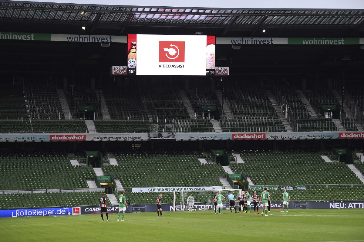 FILE - Empty stands during the German Bundesliga soccer match between SV Werder Bremen and Eintracht Frankfurt in Bremen, Germany, June 3, 2020. Bundesliga players’ salaries reached an all-time high of nearly 1.57 billion euros ($1.74 billion) last season despite a huge shortfall in German clubs’ revenue due to the impact of the coronavirus, it was announced Friday, April 1, 2022. The German soccer league says that the downturn in revenue since the start of the pandemic across the top two divisions has totaled more than 1 billion euros ($1.1 billion). (Stuart Franklin/Pool via AP, File)