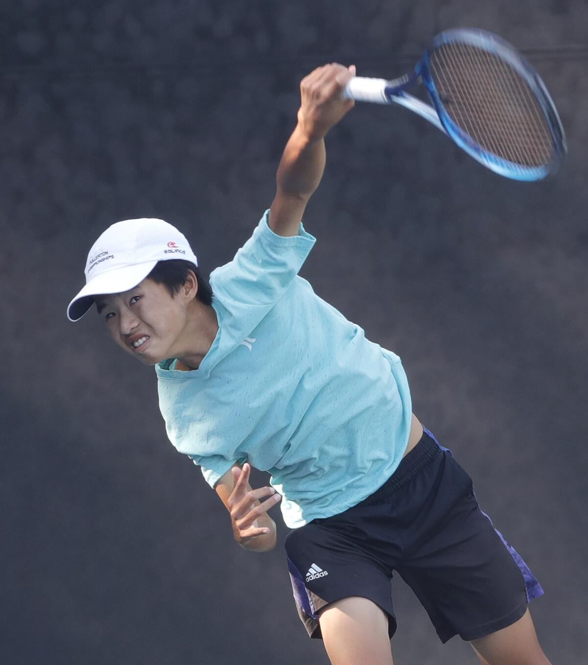 Fountain Valley's David Duong rips a serve in his semifinal match during the War by the Shore junior tennis tournament.