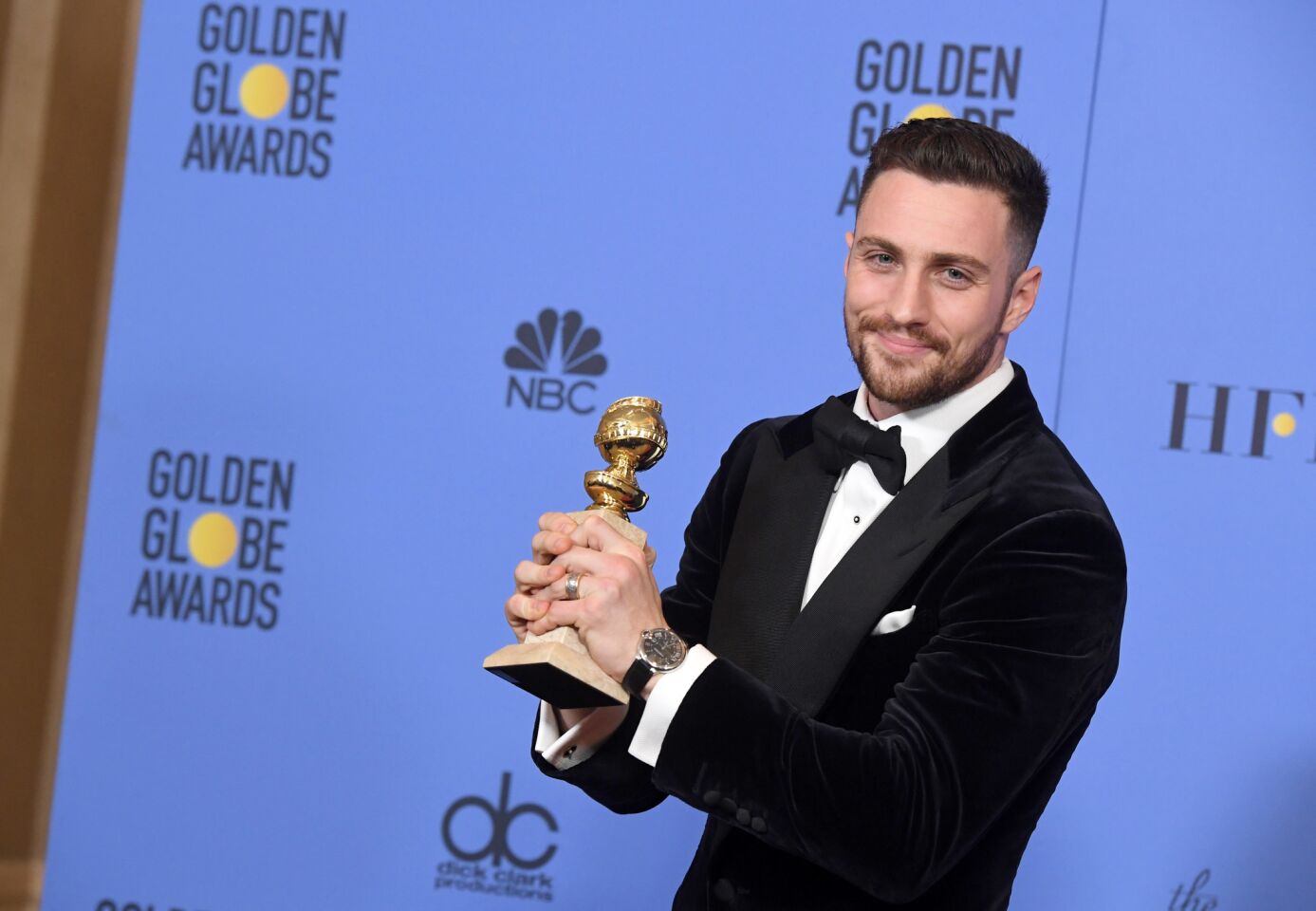 Aaron Taylor-Johnson with his award for supporting actor in a motion picture for "Nocturnal Animals."