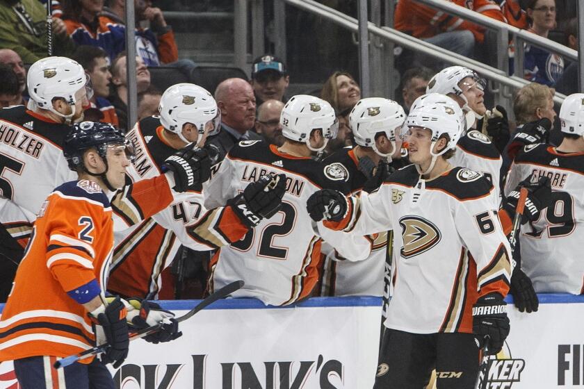 Anaheim Ducks' Rickard Rakell (67) celebrates a goal as Edmonton Oilers' Andrej Sekera (2) skates past during the second period of an NHL hockey game Saturday, March 30, 2019, in Edmonton, Alberta. (Jason Franson/The Canadian Press via AP)