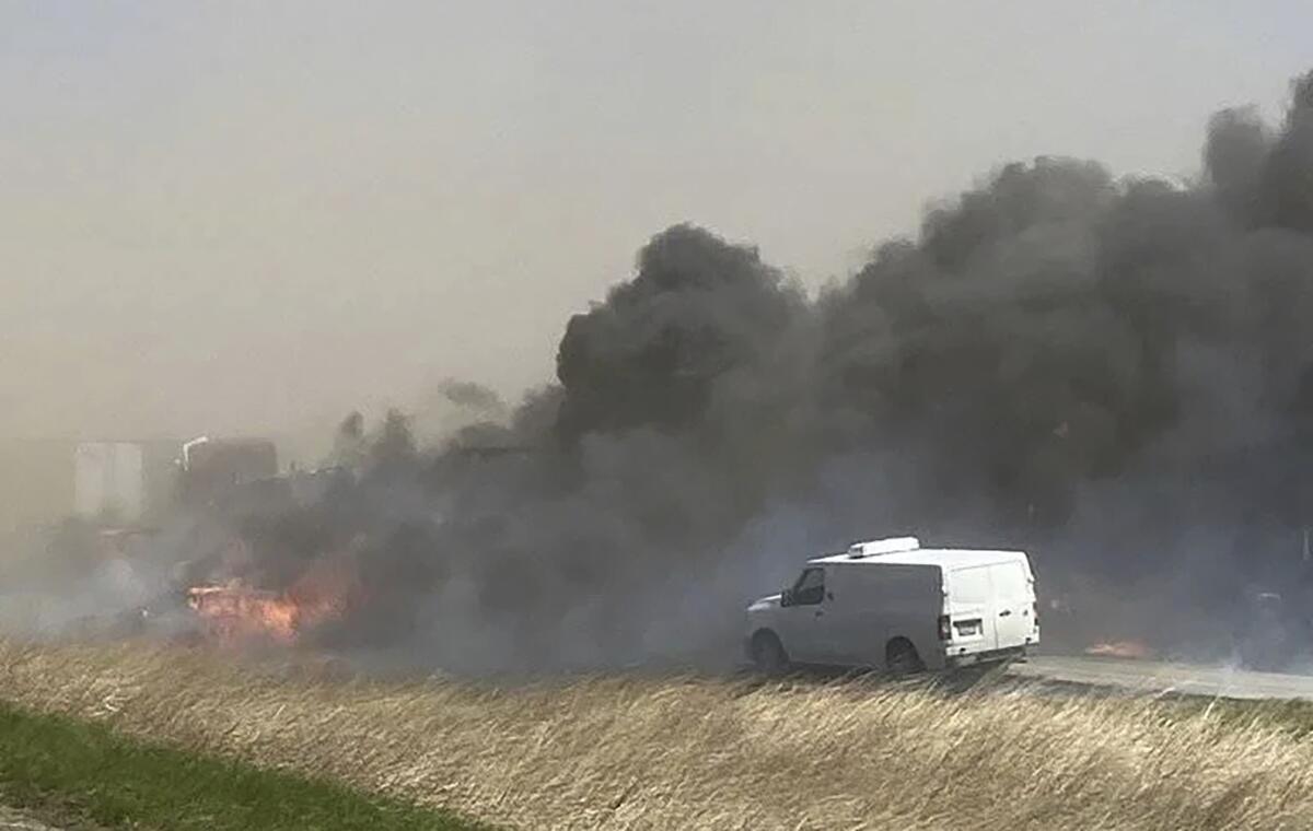 Smoke billows after a crash involving dozens of vehicles shut down a highway in Illinois