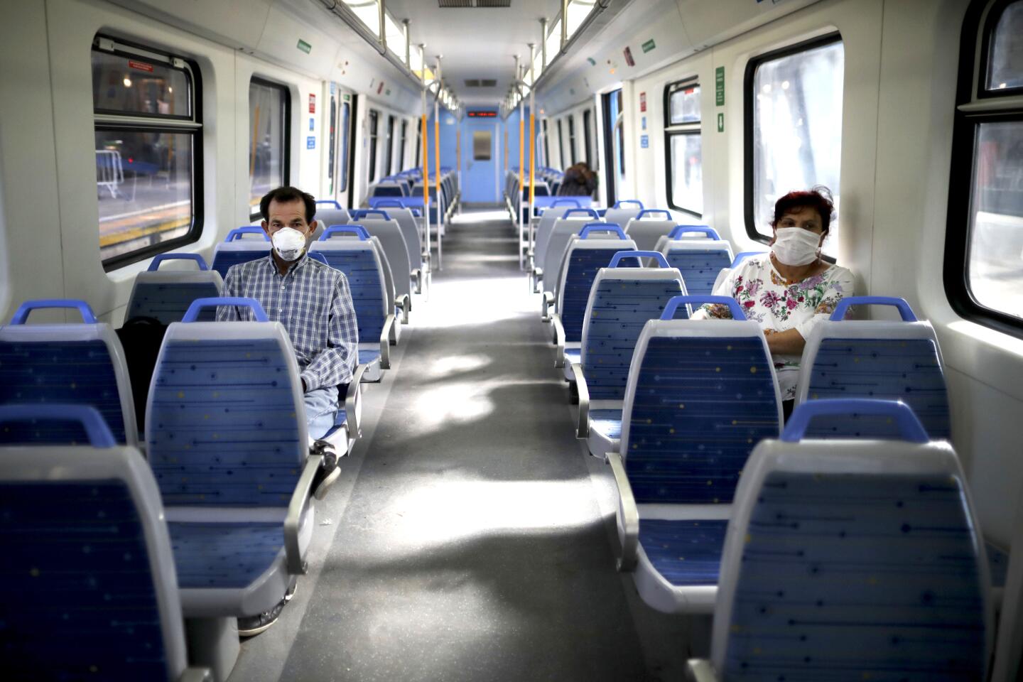 Argentina: People wearing masks as a precaution against the spread of the new coronavirus ride a nearly empty train in Buenos Aires.