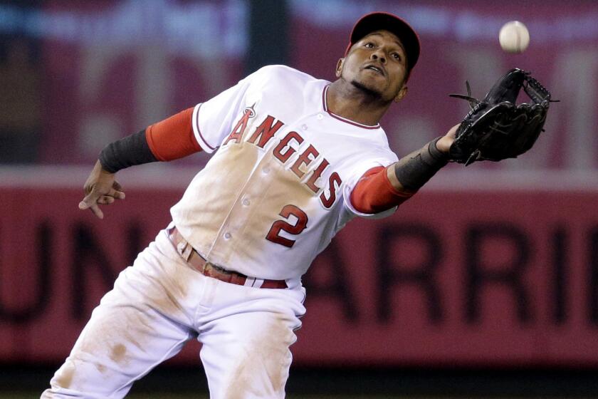 Angels shortstop Erick Aybar catches a fly ball hit by Rockies third baseman Nolan Arenado during the 10th inning of a game on May 13.